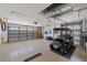 Spacious garage featuring ample storage space, a golf cart, and multiple garage doors at 9652 Oakwood Hills Ct, New Port Richey, FL 34655