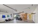 A clean garage with storage cabinets, golf cart, overhead storage, and ample open space at 9652 Oakwood Hills Ct, New Port Richey, FL 34655