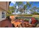 Inviting outdoor patio with comfortable seating and a lush green view at 9652 Oakwood Hills Ct, New Port Richey, FL 34655