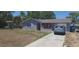 Charming home featuring a stucco exterior, well-maintained lawn, and convenient driveway parking at 10347 Caspian St, Spring Hill, FL 34608