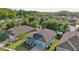 An aerial view captures a light-blue single-Gathering home with an attached two-car garage at 11041 Paradise Point Way, New Port Richey, FL 34654