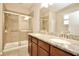 Bathroom featuring double sinks, granite countertops, and a glass walk-in shower with tile surround at 11041 Paradise Point Way, New Port Richey, FL 34654