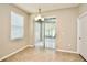 Bright breakfast nook with tile floors, sliding glass doors to backyard, and modern light fixture at 11041 Paradise Point Way, New Port Richey, FL 34654
