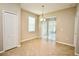 Breakfast nook with tile floors, sliding glass door to the outdoor patio, and modern light fixture at 11041 Paradise Point Way, New Port Richey, FL 34654