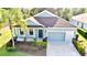Charming, light blue single-Gathering home with a two-car garage and lush landscaping at 11041 Paradise Point Way, New Port Richey, FL 34654