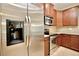 Stainless steel refrigerator and kitchen with stainless steel appliances and wood cabinetry at 11041 Paradise Point Way, New Port Richey, FL 34654