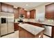 Modern kitchen with stainless steel appliances, granite countertops, and a kitchen island at 11041 Paradise Point Way, New Port Richey, FL 34654