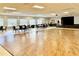 Bright meeting room with wood-look flooring, stage, and plenty of natural light at 11041 Paradise Point Way, New Port Richey, FL 34654