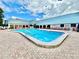 Sparkling pool with lounge chairs under a sunny sky at this community clubhouse at 11041 Paradise Point Way, New Port Richey, FL 34654