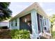 Enclosed lanai with turquoise exterior, offering a relaxed outdoor living space and seamless blend with the backyard at 11041 Paradise Point Way, New Port Richey, FL 34654
