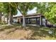 Backyard featuring mature trees, a patio area, and lush greenery with building views at 11241 Dollar Lake Dr # 5, Port Richey, FL 34668