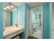 Bright bathroom featuring blue walls, vanity with seating, and views to ensuite at 11241 Dollar Lake Dr # 5, Port Richey, FL 34668