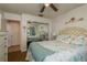 Charming bedroom featuring a coastal theme, queen bed, ceiling fan and mirrored closet at 11241 Dollar Lake Dr # 5, Port Richey, FL 34668