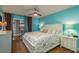 Main bedroom with king bed, brown carpet, and a sliding door with access to patio at 11241 Dollar Lake Dr # 5, Port Richey, FL 34668