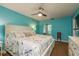 Primary bedroom features a ceiling fan, white furniture, and an ensuite bathroom at 11241 Dollar Lake Dr # 5, Port Richey, FL 34668