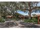 Charming clubhouse framed by mature trees, offering a welcoming entrance and lush surroundings at 11241 Dollar Lake Dr # 5, Port Richey, FL 34668