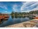 Scenic view of the community dock with a cozy gazebo overlooking calm waters and picturesque surroundings at 11241 Dollar Lake Dr # 5, Port Richey, FL 34668