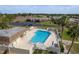 Aerial view of community pool with ample lounge chairs, a cabana and community buildings at 11241 Dollar Lake Dr # 5, Port Richey, FL 34668