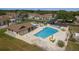 Aerial view of a sparkling community pool with lounge chairs and shaded areas for residents' enjoyment at 11241 Dollar Lake Dr # 5, Port Richey, FL 34668