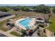 Inviting community pool area with ample seating, lush landscaping, and a shaded pavilion for relaxation at 11241 Dollar Lake Dr # 5, Port Richey, FL 34668