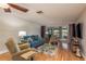 Relaxing living room featuring sliding glass doors and gleaming wood floors at 11241 Dollar Lake Dr # 5, Port Richey, FL 34668