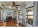 Bright sunroom with wood floors, large windows, and space for pets to enjoy the view at 11241 Dollar Lake Dr # 5, Port Richey, FL 34668