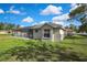 Lush backyard featuring a screened pool area and ample green space for outdoor activities at 11336 Flower Ave, Weeki Wachee, FL 34613