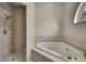 Bathroom featuring a tub and shower combination with neutral tile surround at 11336 Flower Ave, Weeki Wachee, FL 34613