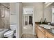 Bathroom with toilet, tub/shower combo, and vanity with granite countertop at 11336 Flower Ave, Weeki Wachee, FL 34613