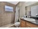 Nicely tiled bathroom featuring granite counters and shower with neutral paint at 11336 Flower Ave, Weeki Wachee, FL 34613