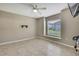 Neutral bedroom with tile floors, ceiling fan, a window, and fresh paint at 11336 Flower Ave, Weeki Wachee, FL 34613