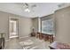 Bright bedroom featuring tile floors, neutral walls, ceiling fan, and a window for plenty of natural light at 11336 Flower Ave, Weeki Wachee, FL 34613