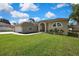 Well-manicured lawn and tasteful landscaping accent the side of this cream colored home at 11336 Flower Ave, Weeki Wachee, FL 34613