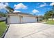 Spacious three-car garage with an extensive driveway offering ample parking space for Gathering and guests at 11336 Flower Ave, Weeki Wachee, FL 34613