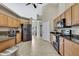 Open-concept kitchen with wood cabinets, granite countertops, stainless steel appliances and tile floors at 11336 Flower Ave, Weeki Wachee, FL 34613