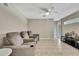 Open living room with tile flooring, ceiling fan, neutral walls, and comfortable seating at 11336 Flower Ave, Weeki Wachee, FL 34613
