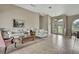 Comfortable living room with neutral decor, tile floors, and large windows creating a bright and airy atmosphere at 11336 Flower Ave, Weeki Wachee, FL 34613