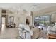 Beautifully staged living room with high ceilings, neutral colors, and large windows offering outdoor views at 11336 Flower Ave, Weeki Wachee, FL 34613