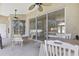 Comfortable outdoor patio featuring ceiling fans and sliding door entrance at 11336 Flower Ave, Weeki Wachee, FL 34613