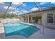 Sparkling screened-in pool featuring a spacious patio, ideal for entertaining and leisure at 11336 Flower Ave, Weeki Wachee, FL 34613
