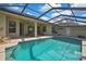 Inviting screened pool with ample patio space and a covered lanai for outdoor enjoyment at 11336 Flower Ave, Weeki Wachee, FL 34613