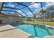 Screened pool with clear blue water and a spacious patio area for entertaining and relaxation at 11336 Flower Ave, Weeki Wachee, FL 34613