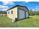 Spacious two-door storage shed in backyard with lush green grass and sunny sky at 11336 Flower Ave, Weeki Wachee, FL 34613