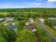 Aerial view of a quaint neighborhood featuring lush greenery and a pool at 12331 Fulmar Rd, Weeki Wachee, FL 34614