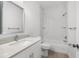 Bathroom featuring a tub with shower, large mirror, and white vanity with quartz countertop at 12331 Fulmar Rd, Weeki Wachee, FL 34614