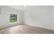 Neutral bedroom featuring light wood floors and a window at 12331 Fulmar Rd, Weeki Wachee, FL 34614