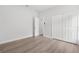 Bright bedroom features light wood floors, and a closet for ample storage at 12331 Fulmar Rd, Weeki Wachee, FL 34614
