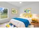 Bedroom featuring a bed, bedside tables, lamps, rug, and window with a view of the outdoors at 12331 Fulmar Rd, Weeki Wachee, FL 34614