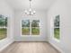 Dining room with modern chandelier, and large windows offering an abundance of natural light at 12331 Fulmar Rd, Weeki Wachee, FL 34614