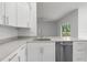 View of kitchen featuring modern stainless steel appliances, white cabinets, countertops and sink at 12331 Fulmar Rd, Weeki Wachee, FL 34614